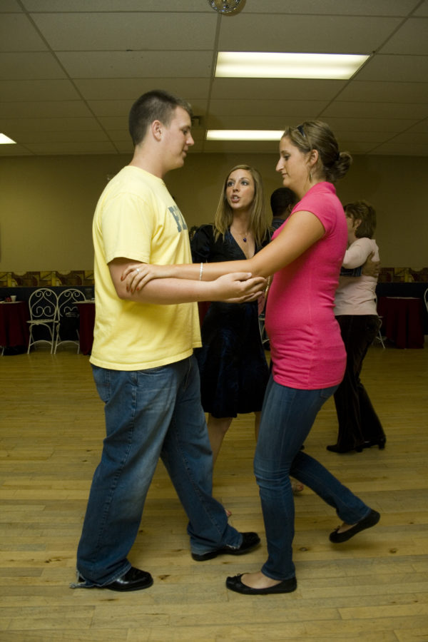 A NIGHT TO REMEMBER: At Arthur Murray Dance School, reporters Lexi Muir and Bennett Fuson practice the rumba as instructor Danielle looks on. MICHELLE HU / PHOTO