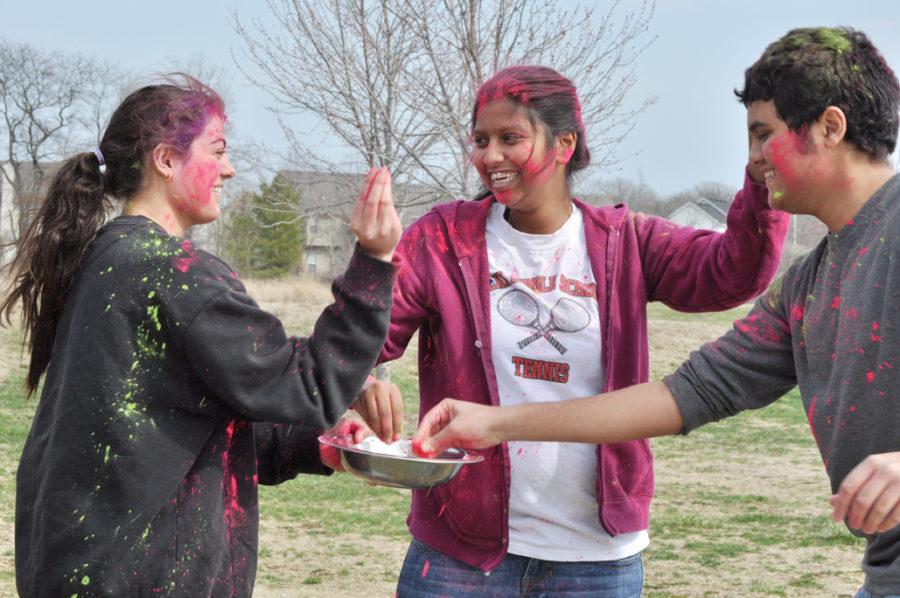 JOIN THE fun: Juniors Nimisha Kumar (middle) and Nikhil Dharan (right) throw Holi colored powders at each other at Lawrence W. Inlow Park. Holi is an Indian festival that marks the advent of the spring planting season.