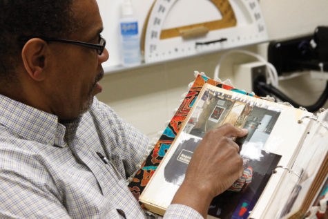	       Michael Thomas, former Peace Corps volunteer and physics teacher, shows a scrapbook of pictures from his stay in Namibia. For Thomas, volunteering with the Peace Corps not only had an impact on his outlook on life but also inspired him to become a teacher. 