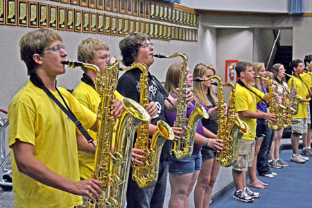 Members of the marching band rehearse their music during a morning session. The band practices Tuesday to Friday from 6:55 to 7:40 a.m. and from 3:45 to 6 p.m. at the stadium, in addition to Saturday practices. RACHEL BOYD / PHOTO