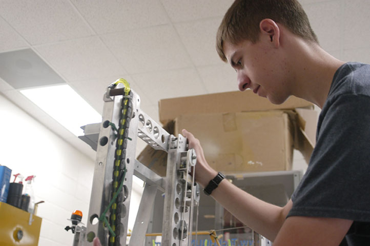 EYES ON THE PRIZE: Ryan Wilmes, TechHOUNDS team leader and senior, performs maintenance on last years competition robot during SRT. According to Wilmes, TechHOUNDS will have its call-out meeting for this school year on Sept. 1 in the community room. MELINDA SONG / PHOTO