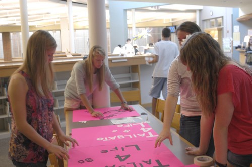     House members senior Hannah Blachly, sophomore Casey Gorin, senior Julie Gaylor, and sophomore Jenna Wiegand (left to right) make posters to promote Tailgate for Life. Tailgate for Life is a House event that will raise money for breast cancer research this year. OMEED MALEKMARZBAN / PHOTO