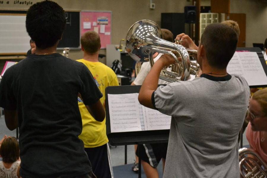 Members of the marching band fine tune competition music during a morning rehearsal. The band practices every day of the week except Sunday and Monday, and these practices will increase in length and intensity as the season continues according to Kathryn Dawson, drum major and senior. RACHEL BOYD / PHOTO