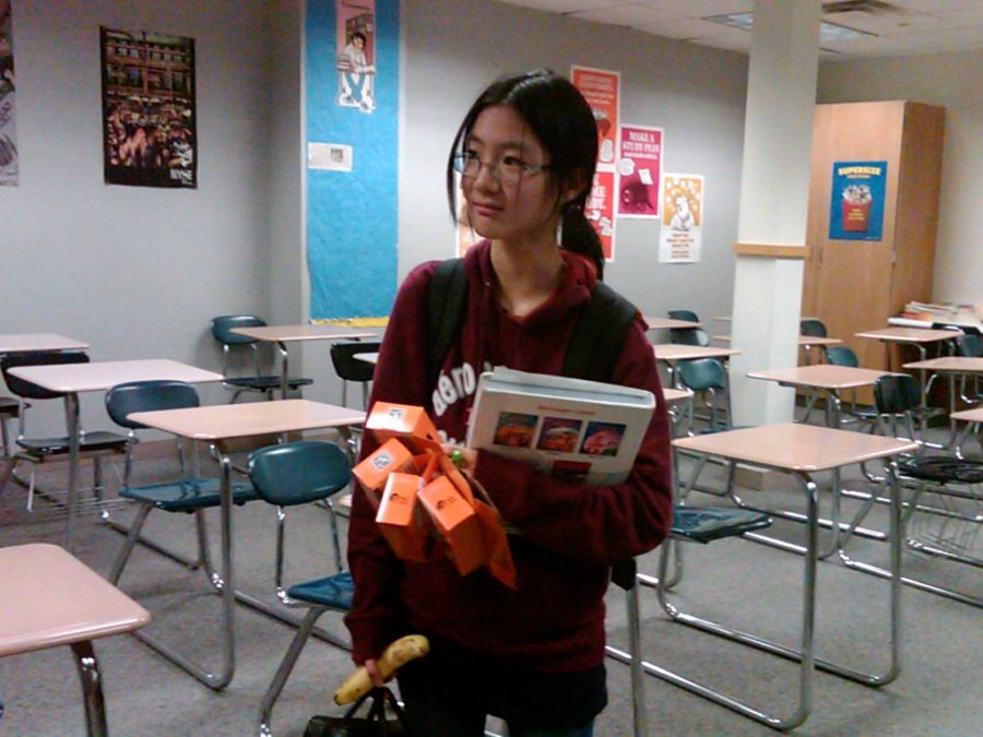 Freshman Cynthia Wu carries the Trick or Treat for UNICEF boxes for Halloween fundraising. Unicef club plans to donate all proceeds to organizations such as those helping the people affected by the disaster in Haiti. ERIC HE / PHOTO