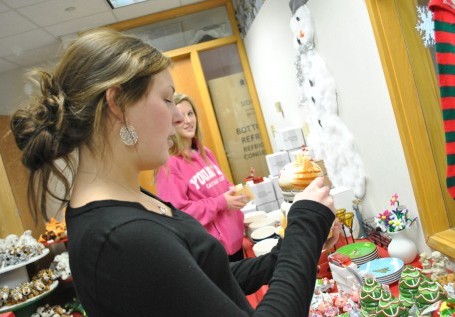 SANTA’S SHOP: DECA member and senior Lydia Clark organizes and looks through the items for sale in Santa’s Secret Shop, opened by DECA. Students can visit Santa’s Secret Shop through Dec. 7. SARAH YUN / PHOTO