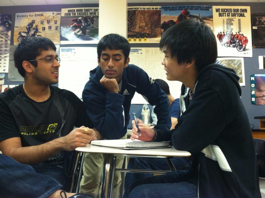 Seniors (from left) Sahil Sanghani, SriHari Vishnubhotla and Julian Kim discuss their notes during a break time in Thomas Maxam’s AP Biology class.  Sanghani said he takes science classes like Maxam’s out of interest and college preparation as opposed to expecting to be able to use his AP credit in college. PATRICK BRYANT / PHOTO