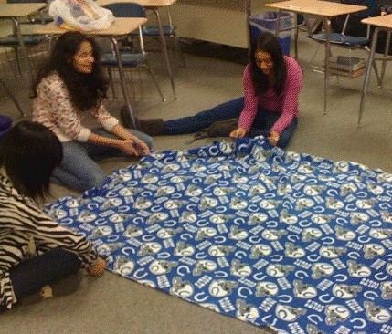 Junior Heera Vemaganti works on a fleece blanket with other Do Something Club members. Club members recently donated fleece blankets to Joys House, a battered womens shelter in Indianapolis. JOHN DU / PHOTO