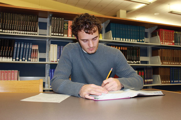 Practice Makes Perfect: Junior Nick Johnson studies in the library. According to Johnson, who had an IQ of 128 when he was 10, studying and a desire for knowledge helps foster a higher IQ.