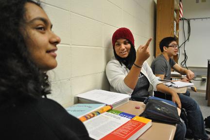 TIPS FOR A TUTOR: Aghilah Nadaraj, Students for Education vice president and senior, gestures as she explains the club’s work to senior Shreeya Raman. Nadaraj said newer members like Raman have been eager to participate in both the fundraising and tutoring activities. HENRY ZHU / PHOTO