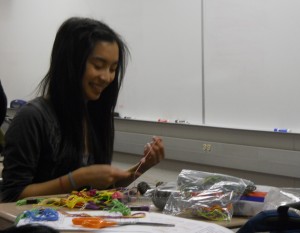 Tiffany Yeh, Do Something Club member and junior, makes a bracelet at a club meeting. Do Something Club members are collaborating with students from Zionsville High School to make bracelets to raise money for Heifer International. JOHN DU / PHOTO