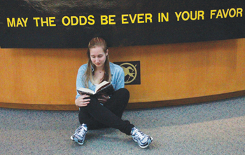 FAVORABLE ODDS: Raven Peterson, avid reader of the book series and senior, reads a novel in the media center. Peterson said after watching the film’s trailer, she read the entire book series. HAILEY MEYER / PHOTO
