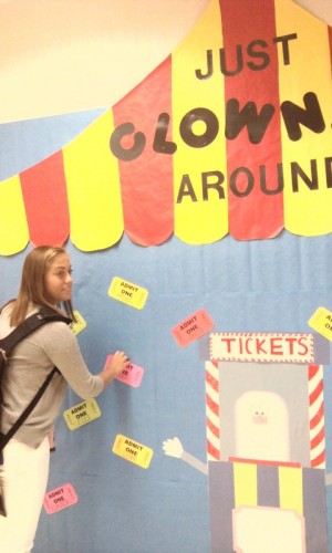 Morgan Gee, Kids’ Corner member and senior, places finishing touches on one of the bulletin boards outside the classroom. She said she and the seniors decided to put up all of the decorations for each week early to save time later in the semester. OLIVIA WEPRICH / PHOTO