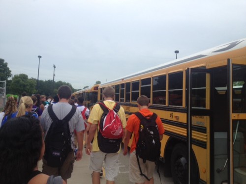 Students walk to their buses after school by the natatorium parking lot, a traditional bus pick-up area. Ron Farrand, director of facilities and transportation, said there have not been many changes to the buses and their routes this year. DHRUTI PATEL / PHOTO  