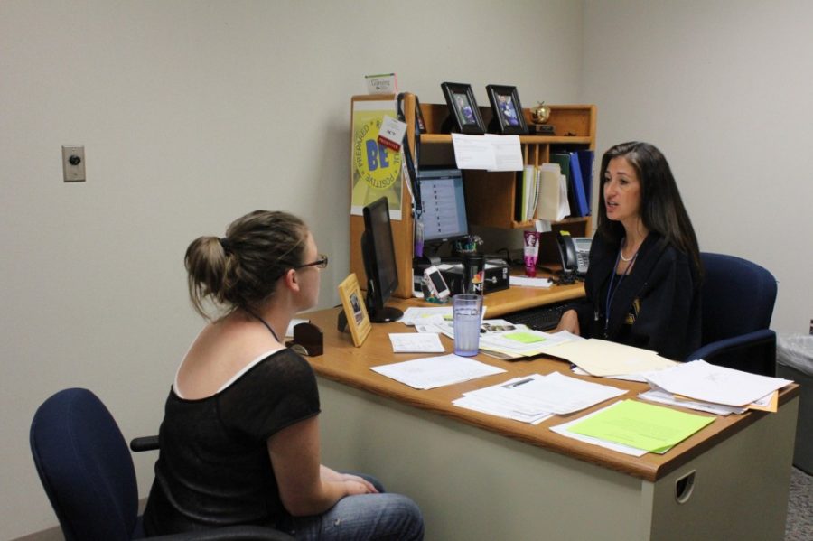 Newly hired college coordinator Linda Christy speaks with senior Michaela Carpenter about her college options.