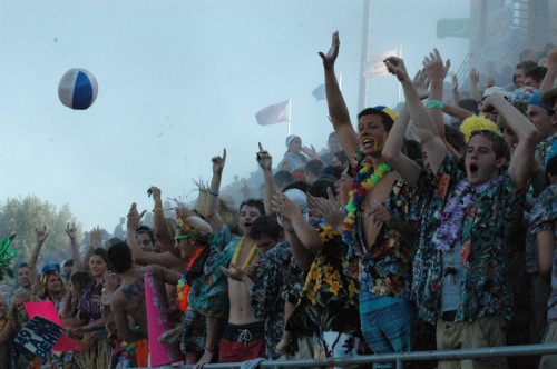 Students in the stands cheer before a home football game amid a cloud of baby powder. Administrators are trying to phase out the tradition of throwing baby powder from the stands before games with a new tradition of shooting confetti poppers. NIKHITA SAMALA / PHOTO
