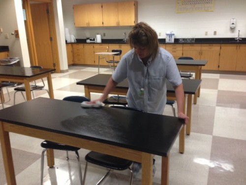 Custodian Susie Denson cleans the tables in a science classroom located in the E hallway. According to assistant principal Doug Bird, along with routine activities, the maintenance and custodial departments are preparing the school for the winter months. CLAUDIA HUANG / PHOTO
