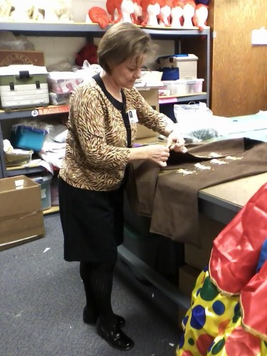 Parent volunteer Linda Tatum works on a costume for the Holiday Spectacular. The Holiday Spectacular opens on Dec. 5.