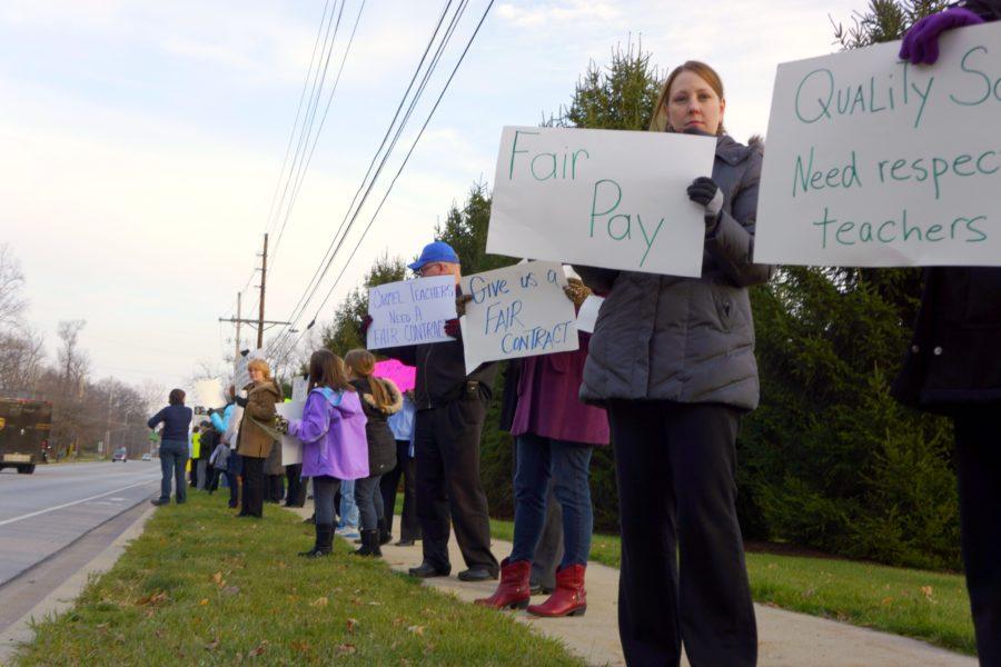 Teachers, students, and concerned parents protest the new teacher contract in front of Woodbrook Elementary School. The protest was held to raise awareness of the on-going negotiations of teacher salary, work day and benefits. ARUNI RANAWEERA/ PHOTO