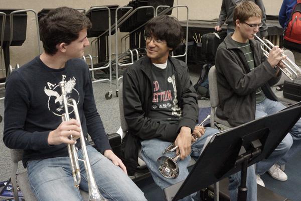 distracted: Senioritis victim Keshav Ramaswamy talks to a friend during his band class instead of paying attention to the music. Alternate schedules that have been proposed for future seniors may help to subdue this lack of attention that comes with senioritis. SAM PATTERSON/ PHOTO