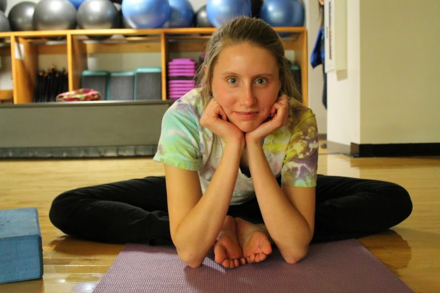 Senior Rachel Peterson sits in the yoga studio. Peterson said yoga is safe and beneficial as long as practitioners take the necessary precautions. NIVEDHA MEYYAPPAN / PHOTO