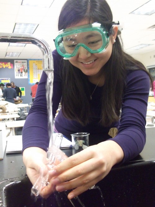 Katie Gao, AP Chemistry student and junior, cleans up test tubes after a chemistry lab. Science fairs, such as the one at Smoky Row elementary, are a precursor to high school science labs. ROCHELLE BRUAL / PHOTO