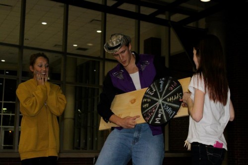 Grant Goodman, Young Life member and senior, spins the “Wheel of Misfortune” during a Young Life Club Meeting. Other meeting activities include singing, raffle prizes and guest speakers. OLIVIA WALKER / PHOTO