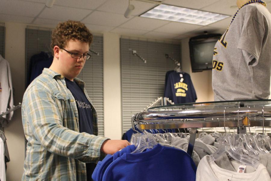 Sophomore Matthew “Matt” McDonald looks at clothes from the CHS Spirit Shop in the store. McDonald said he prefers to shop American-made products because doing so benefits the economy. CRYSTAL CHEN / PHOTO