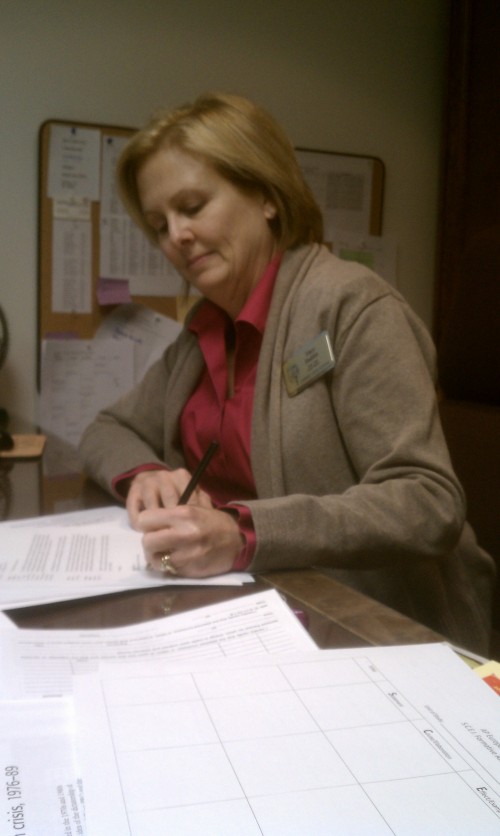 Tracy Hadden, Africa Awareness Club sponsor, fills out paperwork for the Africa Awareness Club. These particular letters will go to the Invisible Children and Falling Whistles organizations, and will serve to allocate funds toward combating violent conflicts in Uganda and the Congo. JACOB WORRELL / PHOTO