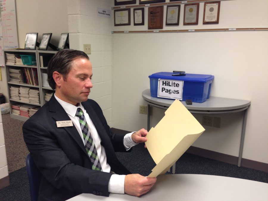 Superintendent Nicholas Wahl peruses over documents. Wahl said that he hopes to evaluate and improve current academic programs depending on what is best for student growth.