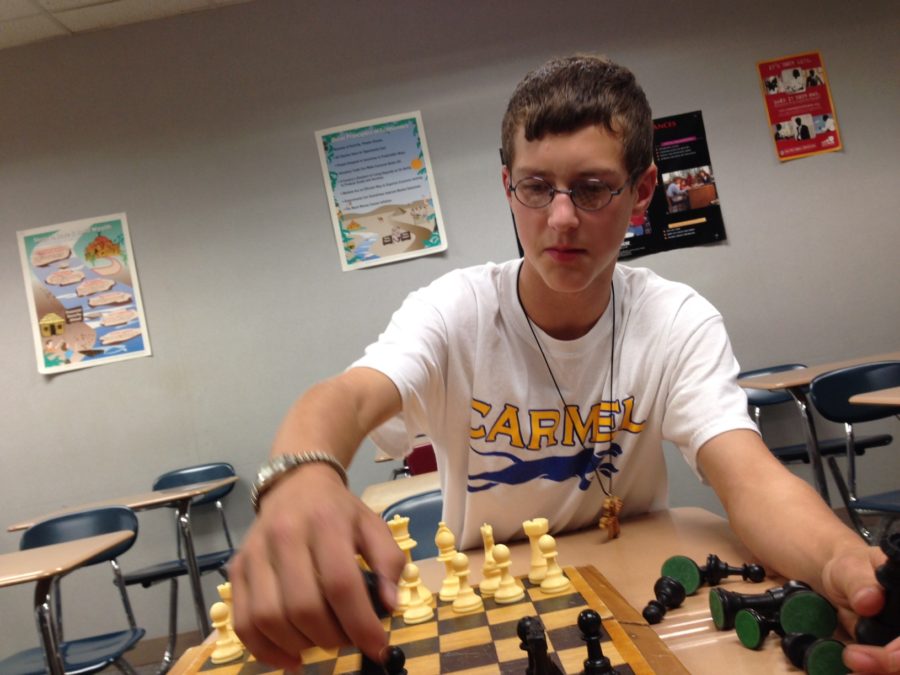James Moskal, freshman and club member, sets up a game of chess. Moskal said he was looking forward to attending many of the upcoming events for Chess Club. ASTER SAMUEL / PHOTO