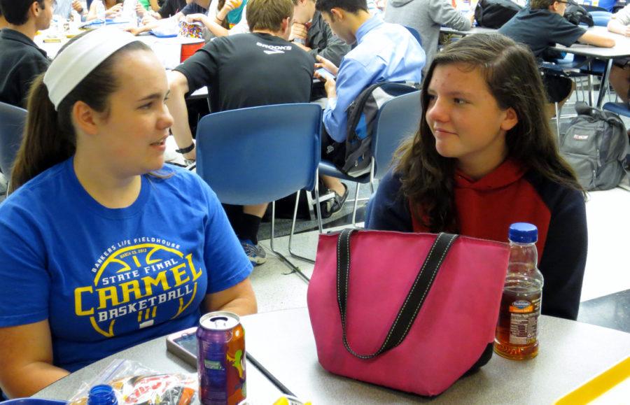 Junior Emily Cornwell (left) and Cathleen Schmalfuss (right), the German exchange student who Cornwell hosts, talk to each other during lunch. Both Cornwell and Schmalfuss hope to improve in German and English, respectively, during the exchange. SARAH LIU / PHOTO