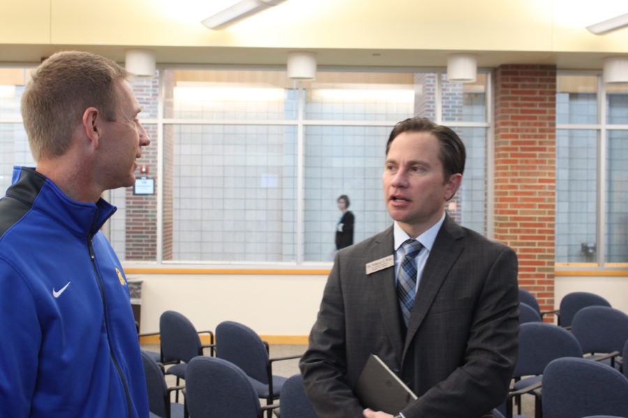 Superintendent Nicholas Wahl speaks to Kevin Wright, head coach of the football team, after a teacher award ceremony that took place on Nov. 1. Wahl said he hopes to increase communication with teachers, parents and students across the district. JOSEPH LEE / PHOTO
