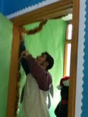 Mitchell Morfas, DECA president and senior hangs up decorations in a display for Holiday Secret Shop. Morfas said the DECA members are trying to put up a lot of decorations and make it as crazy and possible. CHRISHAN FERNANDO / PHOTO