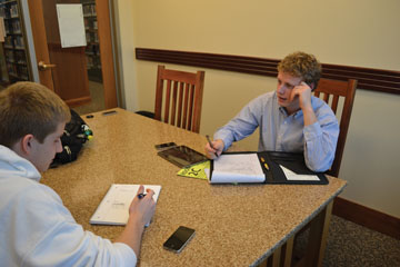 CMYC president Jack Langston ‘14 and Matt Klineman, CMYC officer and junior, plan for the Say No to Snow project. The project involves shoveling snow off of sidewalks near the school which would allow for easier commute for walkers. NATALIA CHAUDHRY / PHOTO