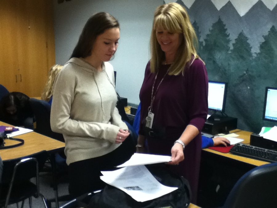 Abby Jensen, DECA member and senior, discusses her business plan for her DECA event with DECA sponsor Laura Cardamon. She is among the many DECA members who are preparing for the state competition. CHRISHAN FERNANDO / PHOTO
