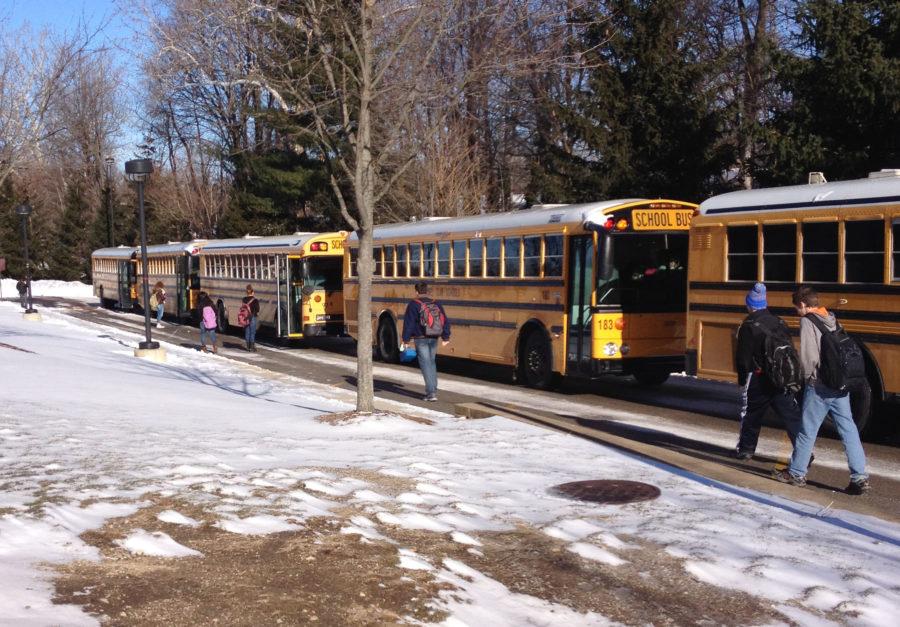 Students board the buses after school. The school board will take action regarding a resolution to protect the school’s transportation and capital projects funds. ANDREW WANG / PHOTO