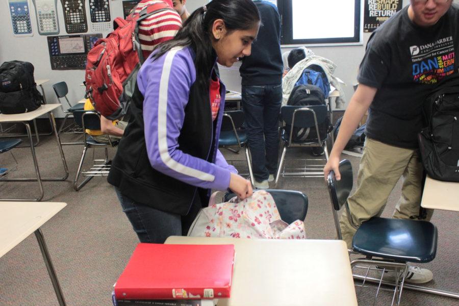 Divya Sarda, Teen Library Council (TLC) vice president and senior, packs up after class. TLC members organize events such as the annual pajama party, but they still encourage students to attend other programs like Dine on a Dime. RUSHI PATEL / PHOTO