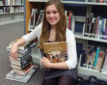  Senior Shelby Hiter leans on a stack of books about World War I and World War II.  She has always had a strong interest in history, particularly the history of our nation.
SWETHA NAKSHATRI / PHOTO