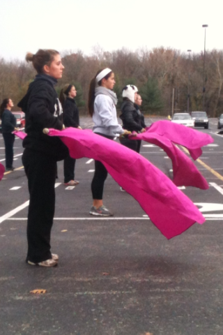Members of guard practice working with flags. They are preparing for upcoming competitions. KYLE WALKER / PHOTO