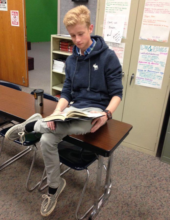 Sophomore class president Jordan (J.D.) Arland reads a book in his CHTV class. He said he looks forward to planning the rest of the year for the sophomores.
