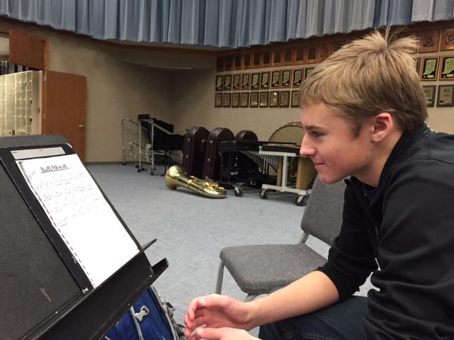 Max Dunn, trumpet player and sophomore, examines his audition piece, an excerpt from Blues for Alice by Charlie Parker. According to Dunn, he auditions for Jazz Ensemble because jazz is his favorite type of music to play. KATIE LONG/PHOTO