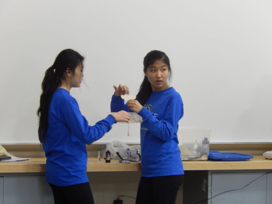Junior+Stephanie+Zhang+prepares+with+a+teammate+for+the+competition.+During+the+next+meeting%2C+builders+will+be+able+to+work+on+their+machines.