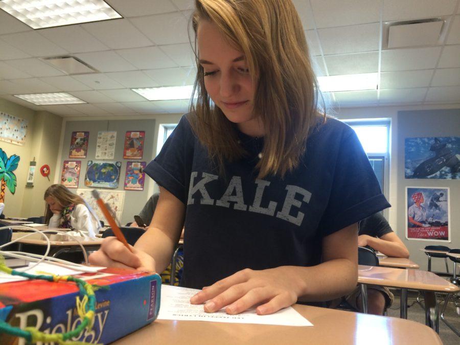 Freshman Anna Fagin does her homework during SRT. She said that she is one of the musicians who will be performing at the Rock and Roll Hall of Fame and Museum in Cleveland, OH. LAXMI PALDE / PHOTO