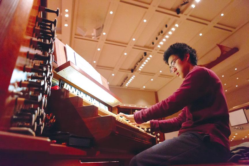 Junior Joseph Huang plays the pipe organ located in St. Lukes United Methodist Church. He said he wanted to continue playing it in order to show that it is not just for religious purposes. KYLE CRAWFORD / PHOTO
