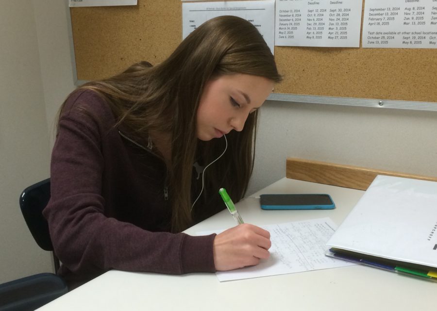 Senior Katie Popcheff works on her homework during third period as a nurses’ aid. Popcheff said, “(Being a nurses’ aid is) pretty low key, I mean, doing homework and stuff, and every once in a while helping out. But it’s a nice break in between classes.”