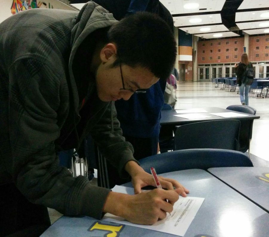  Nathan Fei, Key Club member and sophomore, signs up to volunteer for the Wishbone Race for group hours. Club members can earn volunteer hours at events such as the Cherry Tree Elementary School science fair, where they will help students to make science projects. 