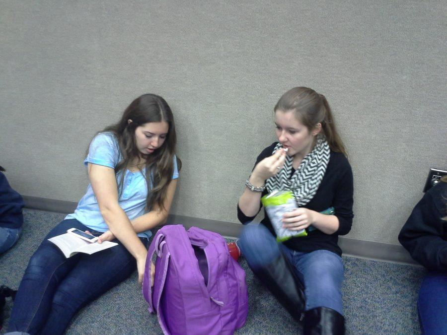 Grace Miller, vice president and junior, eats a snack while she talks with junior Solveig Naumann. She said the club is going to discuss ways to fundraise for the year and the Center for Global Impact fashion show at the next meeting on Feb. 12.