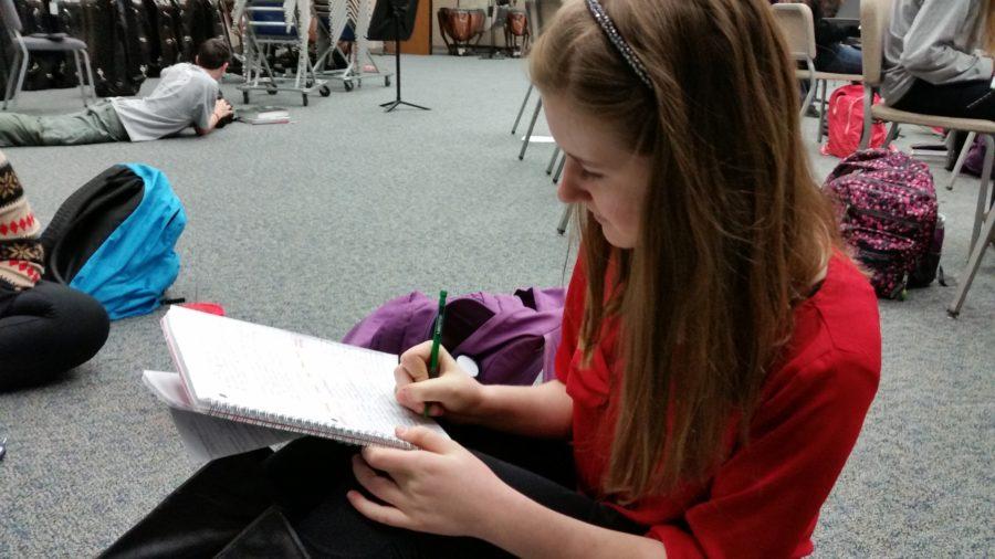 Grace Miller, Living Hope Club vice president and junior, works on homework during SRT. Miller said club members are partnering with Center for Global Impact (CGI) to help out in a fashion show. DEEPTHI THADASINA / PHOTO