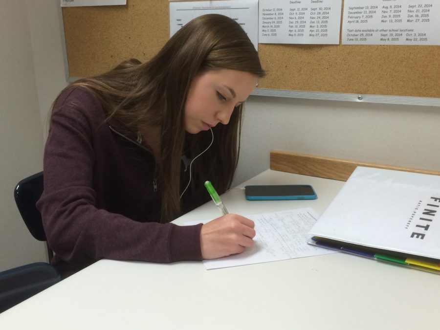 Senior Katie Popcheff works on her homework during her period as a nurses’ aid. Popcheff said, I havent had to run passes as much during this period as a nurses aid, so its pretty uneventful.