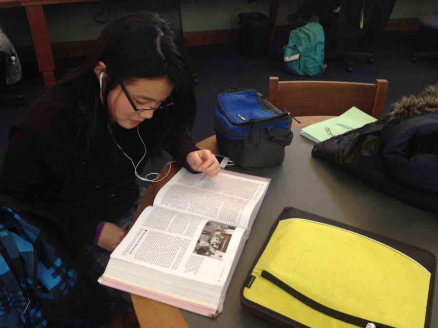 Olivia Wang, Symphony Orchestra member and junior, does her homework after school at the Carmel Clay Public Library. She said she always stays there after school before Tuesday orchestra rehearsals start at 6 p.m.